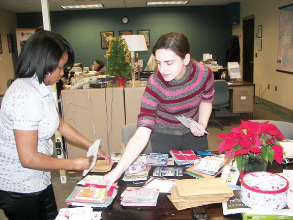 Volunteers sort through cards that are sent to servicemen and women.