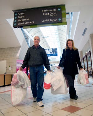 Bill and Denise Urquhart of Easton took advantage of after-Christmas sales at South Shore Plaza on Sunday.