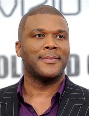 In this Oct. 25, 2010 file photo, Tyler Perry attends a special screening of 'For Colored Girls' at the Ziegfeld Theatre in New York. Entertainment mogul Tyler Perry is offering to rebuild the home of an 88-year-old great-grandmother who lost all her belongings in a fire. Rosa Lee Ransby and her 4-year-old great-granddaughter escaped the fire Tuesday that destroyed her home of 40 years in Coweta County, southwest of Atlanta. Coweta County firefighters began soliciting donations, and calls flooded in. (AP Photo/Evan Agostini, File)