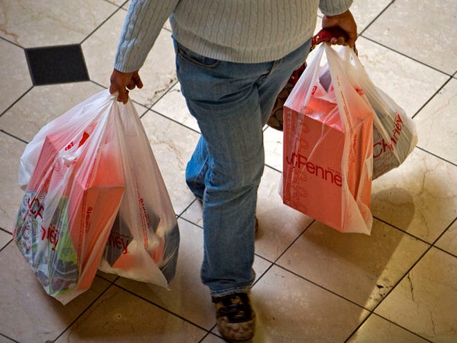 A shopper at the Brea Mall in Brea, Calif., carries bags full of packages Sunday, Dec. 26, 2010. So far, it's been the best holiday season for retailers since 2007, which was a record year. (AP Photo/Orange County Register)