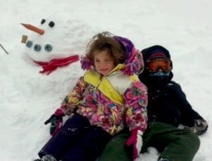 Asher, 5, and Leila, 3, Oren build their first snowman in Monday’s blizzard.