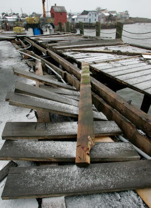 The wharf at T-Wharf in Rockport was pulled up by the waves during high tide early in the monring Dec. 27, 2010.