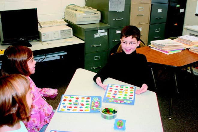 John Mattan playing bingo with Abby and Isabel Sikorski. Stacia Mattan wanted John to be enrolled in general education classes, so he could practice his social skills.