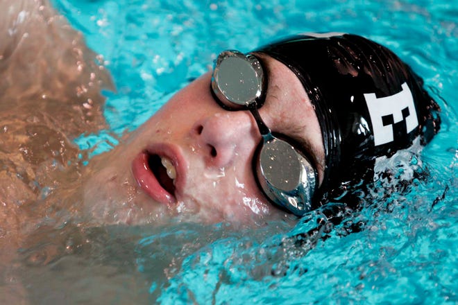Daniel Persinger of East High School takes a breath while competing in the 100-yard backstroke Monday, Dec. 27, 2010, during the Boylan swim invitational in Rockford.
