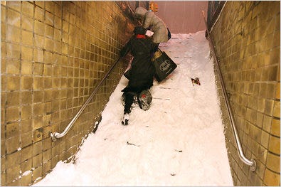 Subway station stairs in New York, like this one on the L stop on First Avenue, about 4 a.m. Monday, were covered with snow.