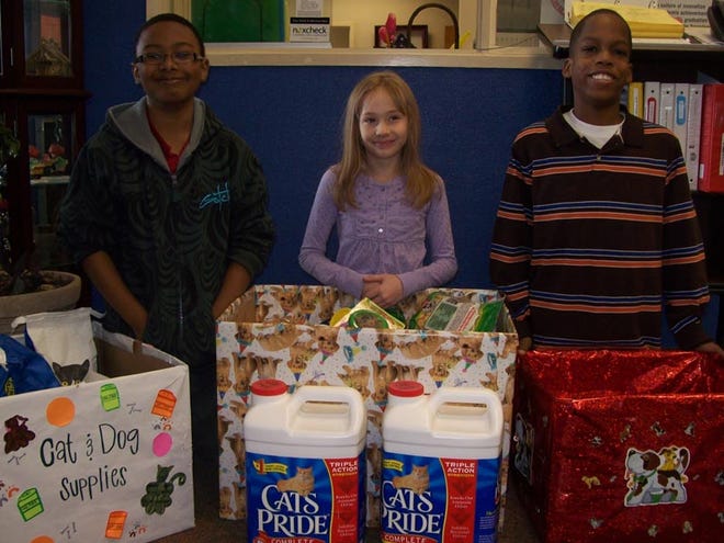 The students of Woodland Forrest Elementary School collected many toys, treats, beds, and food for our furry friends at the Metro Animal Shelter during their annual holiday drive. This event is sponsored by the student council each year. Volunteers and rescued pets will join students for the annual holiday sing along and collect the items for the shelter. (Left to right) Lance Brown, Ciara Leslie, Frenshon Blakely.
