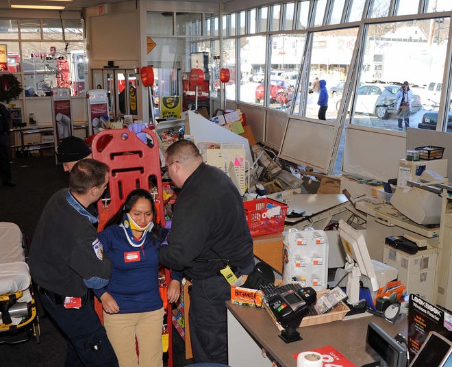 A Weston woman smashed three cars in the parking lot before crashing into the CVS on Main Street in Waltham, Tuesday, Dec. 28, 2010. A cashier at the store and the driver were injured in the accident.