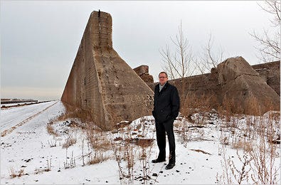 Philip Enquist, of the architecture firm Skidmore, Owings & Merrill, near a masonry wall along an old boat slip from the area’s industrial past.