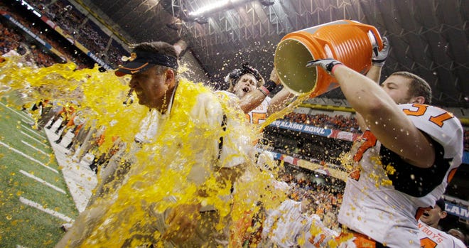 Oklahoma State coach Mike Gundy, with hat, is splashed with a sport as they win the Alamo Bowl NCAA college football game over Arizona, Wednesday, Dec. 29, 2010 in San Antonio. Oklahoma State won 36-10. (AP Photo/Eric Gay)