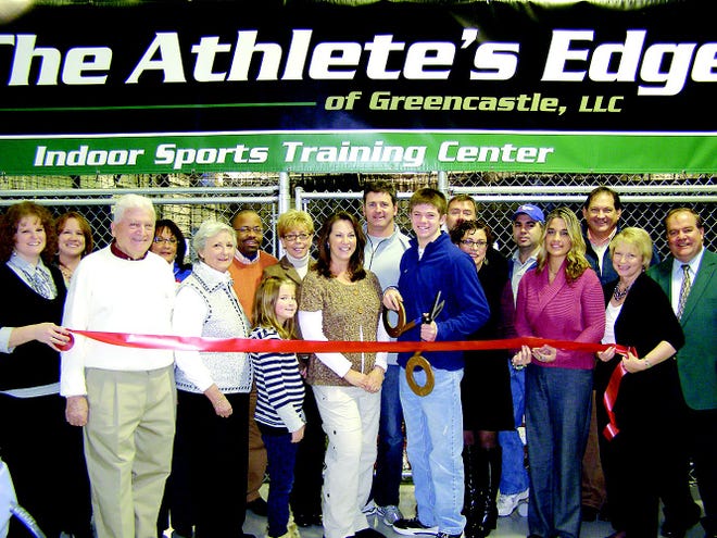 Chuck and Anne Ricci, center, and their children Ryan, 14, and Gabby, 8, held a ribbon cutting ceremony Dec. 10 to announce the opening of The Athlete’s Edge, located at147 N. Antrim Way. They were joined by members of the Greencastle-Antrim Chamber of Commerce. The indoor sports training center caters to baseball, softball, and strength and conditioning workouts for individuals and groups.