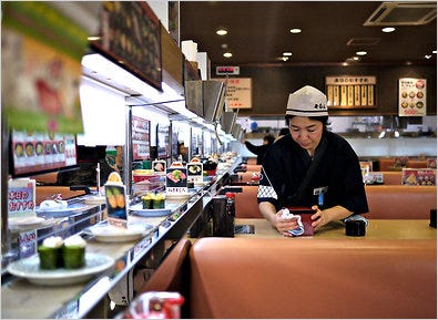 Kura, a chain in Japan, relies on small staffs and lots of automation, like sushi-making robots.