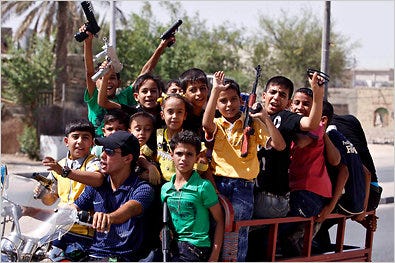 Iraqi children in Basra waved their toy weapons during a holiday in September.