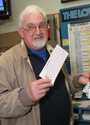 Framingham resident Peter Smith looks to ring in the New Year with a Mega Millions win at Friendly Farm store yesterday afternoon. Smith said his lucky numbers came to him in Chinese fortune cookies.
