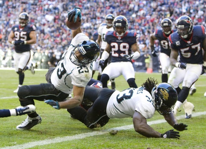 Jaguars running back Rashad Jennings lunges over the goal line for a 3-yard touchdown during the second quarter against the Texans on Sunday. Jennings replaced injured Maurice Jones-Drew.