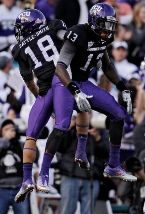 TCU cornerback Travaras Battle (18) celebrates with wide receiver Antoine Hicks against Wisconsin Saturday during the second half of the Rose Bowl. The Associated Press