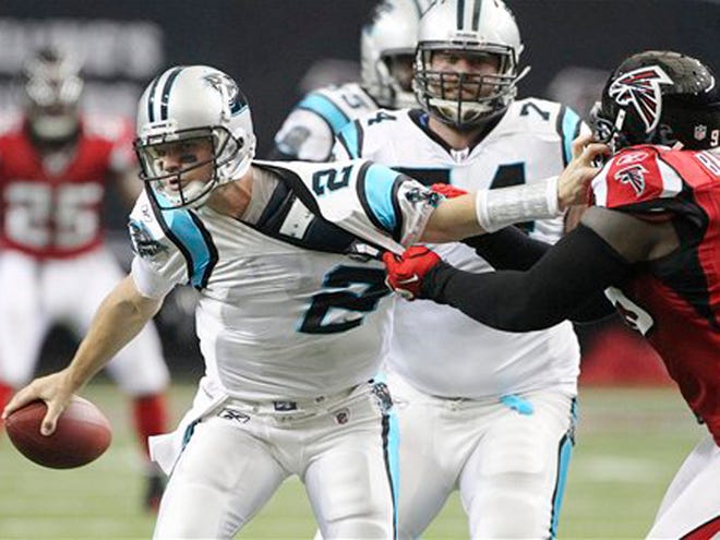 Carolina quarterback Jimmy Clausen (2) is sacked by Atlanta defensive tackle Jonathan Babineaux (95) in the second quarter of an NFL football game Sunday, Jan. 2, 2011 in Atlanta.