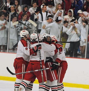 The Hudson boys hockey team celebrates after beating Marlborough 4-1 to win the 11th annual daily News Cup.