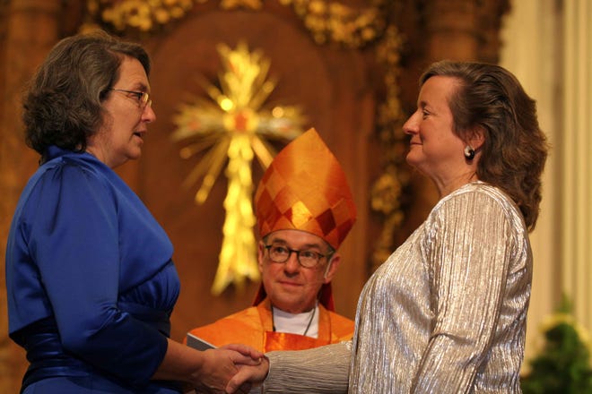 From left, Mally Lloyd, Bishop Tom Shaw and Katherine Hancock Ragsdale at the couple's wedding on Jan. 1, 2011.