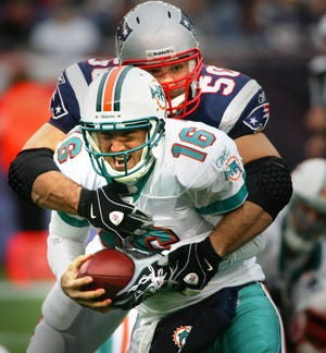 Rob Ninkovich sacks Miami QB Tyler Thigpen during the Patriots' 38-77 victory on Sunday at Gillette Stadium.