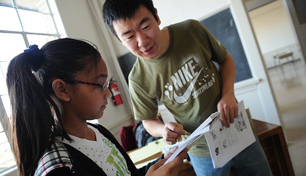 Teacher Paul Zhao works with student Bianca Piedra during a Chinese language class at the Chinese Benevolent Association in Stockton.