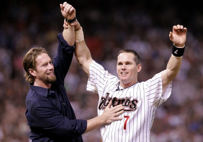 Houston Astros' Craig Biggio is congratulated by former teammate Jeff Bagwell after getting his 3,000th career hit against the Colorado Rockies in a baseball game on June 28, 2007, in Houston.