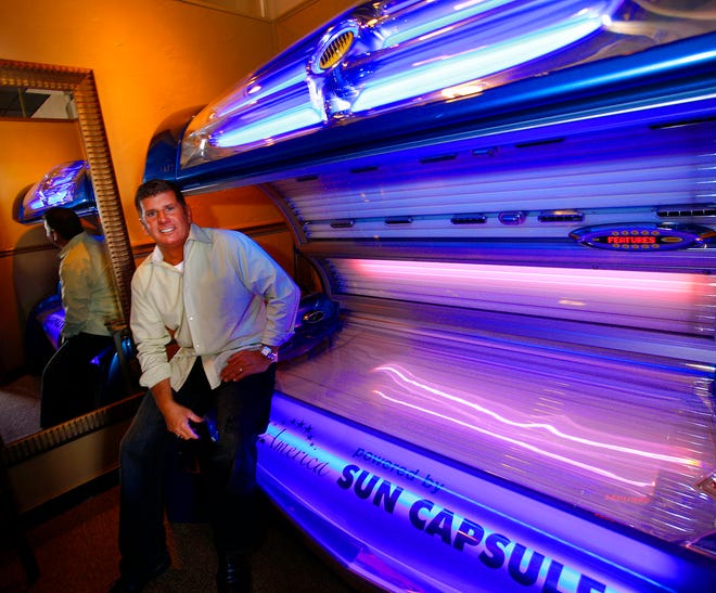 Brian Parrelli, owner of Tanorama in Weymouth, sits near one of his tanning beds Thursday, Dec. 30, 2010. Parrelli said he's purchased two pieces of equipment for the tanning business in the past year that together cost more than $45,000.
