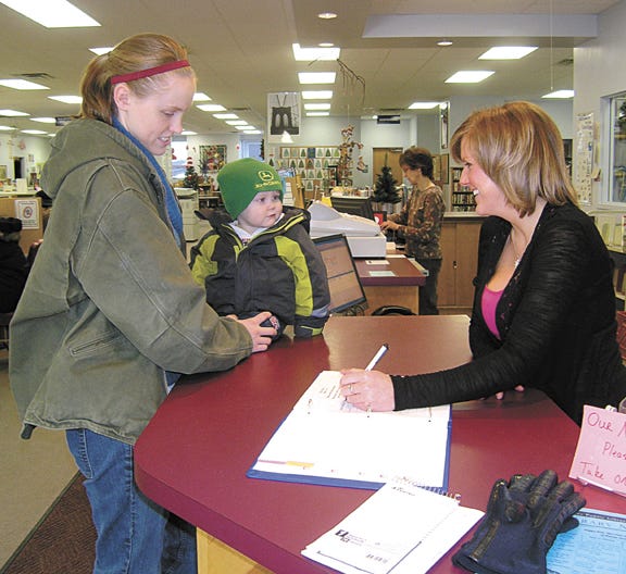Story hour sign-up at Pontiac Public Library began Monday for ages 1-3 years to be known as Tiny Tales. At left, Elisa Thorson signs up her son, Jacob, 1. At right is librarian Melissa Burger.