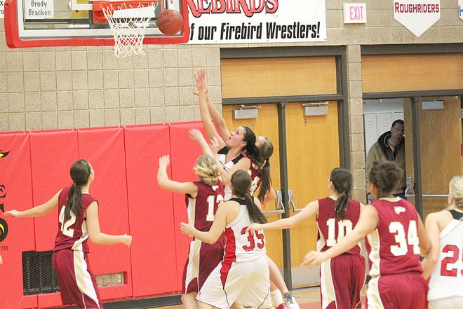 Chelsea Kurtz goes up between a pair of Fargo Davies defenders for two of her seven points during Tuesday’s game at the Devils Lake Sports Center. The Firebirds improved their record to 5-2 on the year with a convincing 59-40 win over the Eagles.