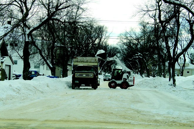 Crews around the city were clearing out the piles of snow lining each street and avenue on Tuesday.