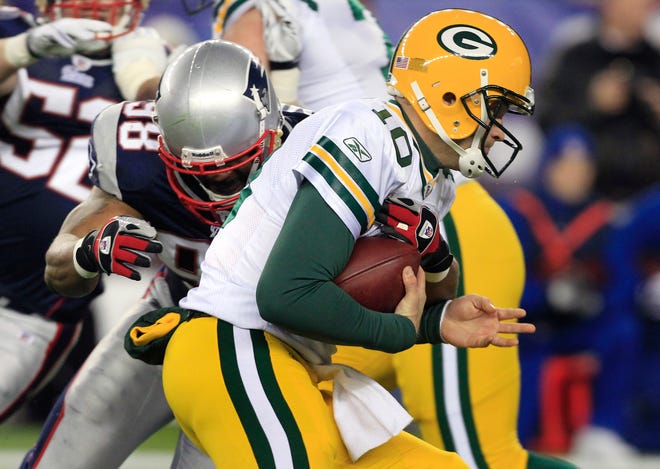 New England Patriots defensive lineman Eric Moore, left, sacks Green Bay Packers quarterback Matt Flynn on Sunday Dec. 19, 2010. Moore played in the United Football League title game in late November and has set his sights on Super Bowl XLV with the Patriots.