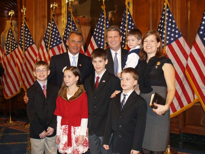 Bill Huizenga, center, and his family get their picture taken with Speaker of the House John Boehner.