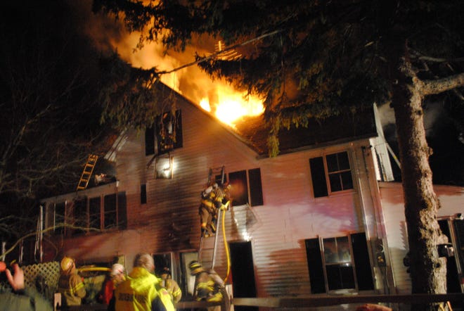 Firefighters battle a fire at 60 South St. in Plymouth on Wednesday, Jan. 5, 2011.