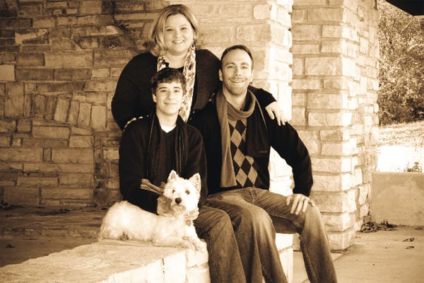 Keli Mrotek, her husband, Dave, and son, Parker, with the family pet.