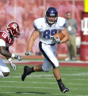 Northwestern football player and Holland Christian graduate Josh Rooks runs with the ball during a game against Indiana.