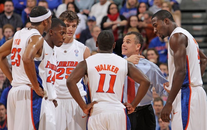Florida coach Billy Donovan (second from right) talks with his team during a timeout against Rhode Island on Jan. 3, in Gainesville. The Gators won, 84-59.