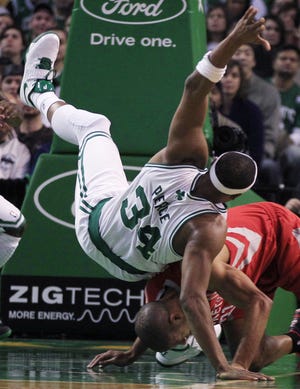 Celtics forward Paul Pierce (34) is upended by Rockets forward Shane Battier during last night's Houston victory.