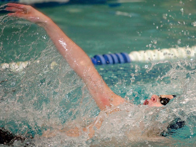 Framingham's Nate Courville takes first place in the 100m backstroke during Tuesday's swim meet against Natick at the Keefe Tech pool.