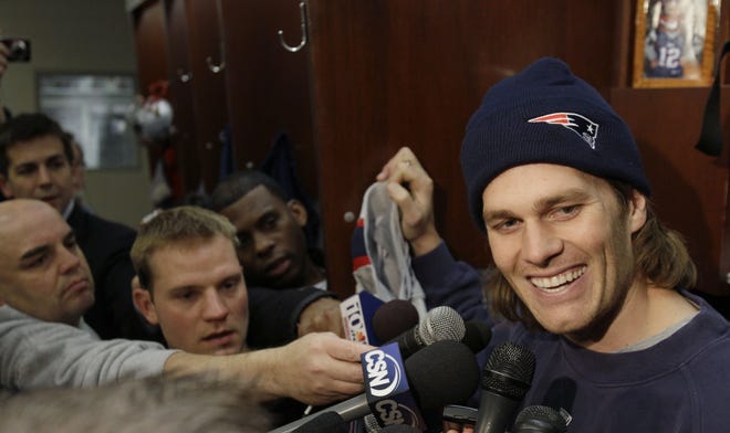 Patriots quarterback Tom Brady, speaks with reporters standing in front of his locker on Wednesday.