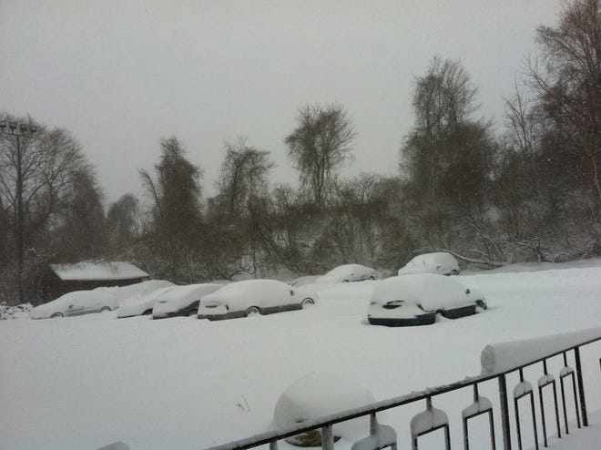 Around eight inches of snow blankets cars at an apartment complex in Pomfret.