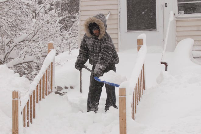 Jamal White of Norwich, shovel a friends walkway Wednesday, Jan. 12, 2011 during the snow storm in Norwich.