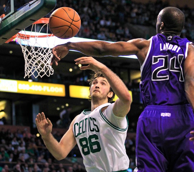 Celtics center Semih Erden battles for a rebound against Kings forward Karl Landry.