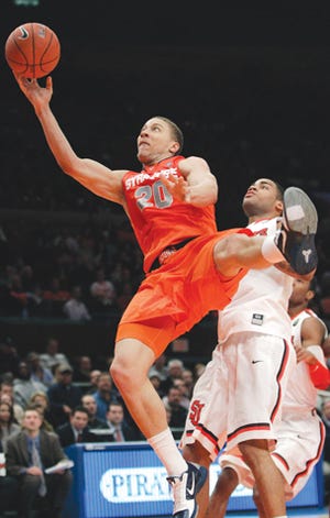 Syracuse Brandon Triche (20) drives past St. John's D.J. Kennedy (1) during the first half of an NCAA college basketball game, Wednesday, Jan. 12, 2011, in New York. (AP Photo/Frank Franklin II)