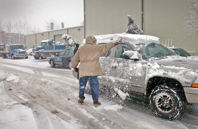 A car owner retrieves his towed vehicle at Schlager Auto Body in Quincy on Wednesday, Jan. 12, 2011.