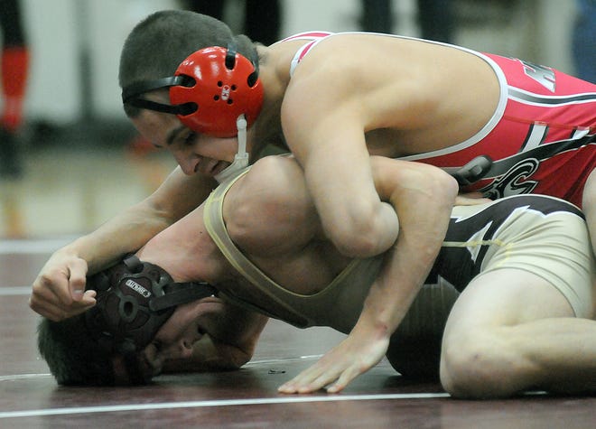 Milford's Richard Santiago (right) controls Algonquin's Chris Brown at 130 pounds during yesterday's Scarlet Hawks win.