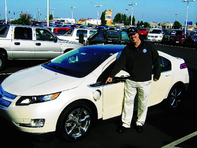 Chase Chevrolet's assistant manager, Chip Kniss, shows off the Volt, Motor Trend's Car of the Year.