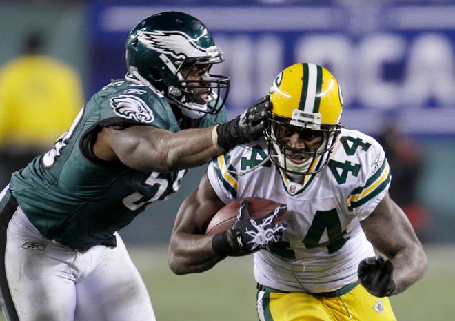 Philadelphia Eagles defensive end Trent Cole, left, reaches for Green Bay Packers running back James Starks (44) during the second half of an NFL football NFC wild-card playoff game in Philadelphia, Sunday, Jan. 9, 2011. The Packers defeated the Eagles 21-16. (AP Photo/Rob Carr)