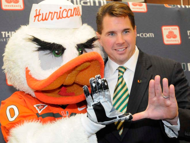 New University of Miami football coach Al Golden practices the U with Sebastian at a news conference in Coral Gables on Dec. 13.