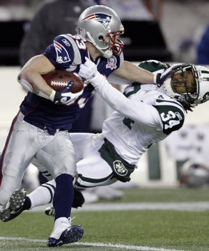 Patriots wide receiver Wes Welker delivers a stiff-arm during New England's win over the Jets.
