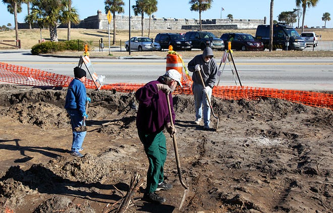 City Archaeologist Carl Halbirt, right, with help from volunteers Janet Gordon, left, and Nick McAuliffe, removes a layer of dirt from a large excavation across the street from the Castillo de San Marcos last week. By DARON DEAN, daron.dean@staugustine.com