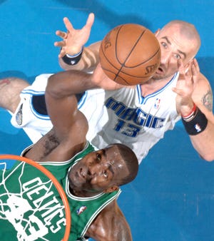 Boston center Kendrick Perkins (43), shown battling Orlando's Marcin Gortat during Game 1 of the Eastern Conference finals last May, hopes to return to the Celtics lineup on Feb. 4.